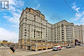Hamilton (Corktown) condo for rent - A large, multi-story building with a flat roof is situated on a street corner.