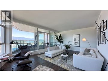 Vancouver apartment for rent - A living room with a white couch and a black chair.