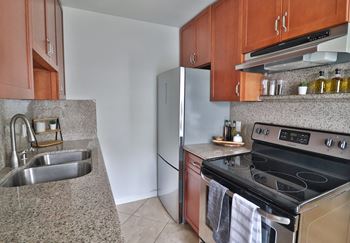Granite countertops and cherry wood cabinets