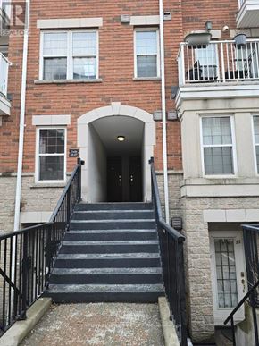 Toronto (York University Heights) townhouse for rent - A staircase with a black railing leads to a doorway.