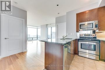 Toronto (Annex) condo for rent - A modern kitchen with wooden cabinets and stainless steel appliances.