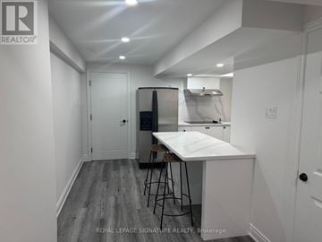 Markham (Village Green-South Unionville) other for rent - A white kitchen with a table and chairs in a room with white walls.