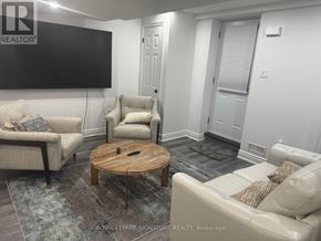 For rent in Markham (Village Green-South Unionville) - A living room with a flat screen TV mounted on the wall.