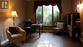 Mississauga (Sheridan) house for rent - A living room with a chair, a desk, and a lamp.