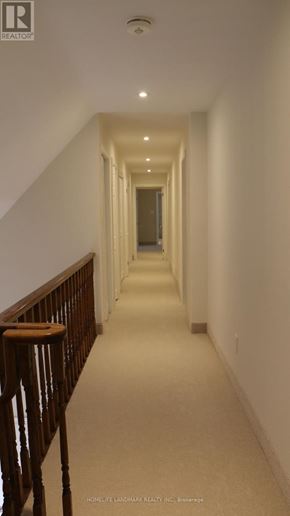 Mississauga (Sheridan) house for rent - A long hallway with a wooden railing on the left side.