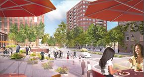 Hoboken apartment for rent - A woman is sitting at a table in a city plaza with people walking around her.