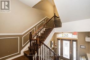 Ottawa condo for rent - A staircase with a wooden banister and a glass door with a sign above it.