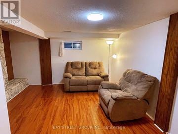 Toronto (Milliken) house for rent - A living room with two couches and a chair.