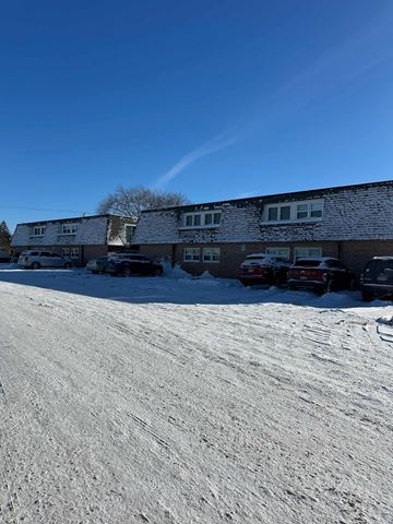 Eau Claire apartment for rent - A snow-covered ground with a building in the background.