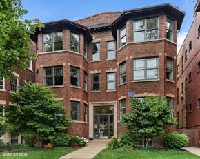Evanston apartment for rent - A brick building with a green lawn in front.