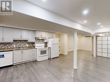 Toronto (Rouge) house for rent - A kitchen with white cabinets and a tile backsplash.