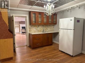 Vaughan (West Woodbridge) other for rent - A kitchen with a white refrigerator and wooden cabinets.