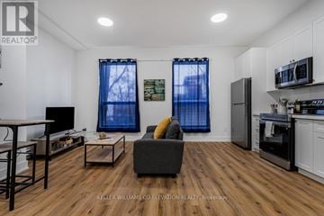 Hamilton (Landsdale) other for rent - A living room with a grey couch and a wooden floor.