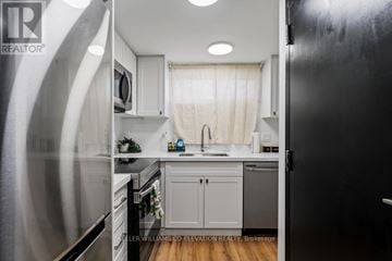 Hamilton (Landsdale) other for rent - A kitchen with a black refrigerator and white cabinets.