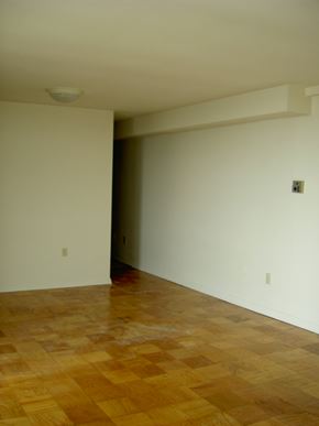 Falls Church apartment for rent - an empty living room with a wooden floor and white walls