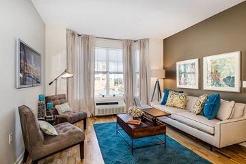Harrison apartment for rent - a living room with a couch and a chair and a table