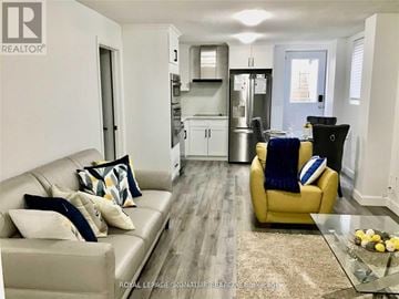 Milton (Co Coates) house for rent - A living room with a yellow chair and a glass table.