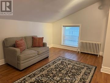 Vaughan (West Woodbridge) house for rent - A living room with a grey couch and a rug.