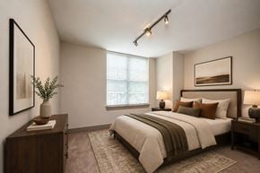 New Orleans apartment for rent - A bedroom with a large bed and a window with blinds.