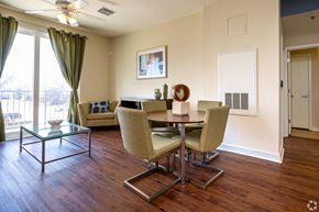 New Orleans apartment for rent - A dining room with a glass table and chairs.