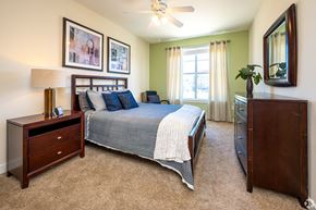 New Orleans apartment for rent - A bedroom with a bed, nightstand, and dresser.