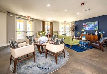New Orleans apartment for rent - A living room with a large rug and a TV on the wall.
