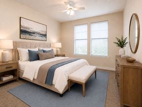New Orleans apartment for rent - A bedroom with a large bed and a painting on the wall.