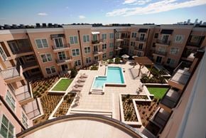 New Orleans apartment for rent - A large apartment complex with a pool and landscaped courtyard.