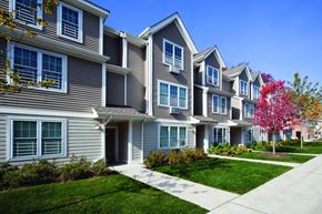 Staten Island apartment for rent - a row of townhomes with grass and trees