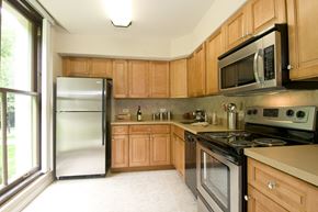 Staten Island apartment for rent - a kitchen with wooden cabinets and stainless steel appliances