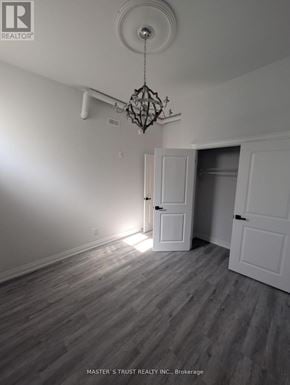 Uxbridge condo for rent - A room with a chandelier and two doors.