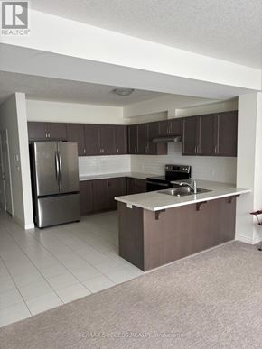 Hamilton townhouse for rent - A hallway with a staircase and a door at the end.