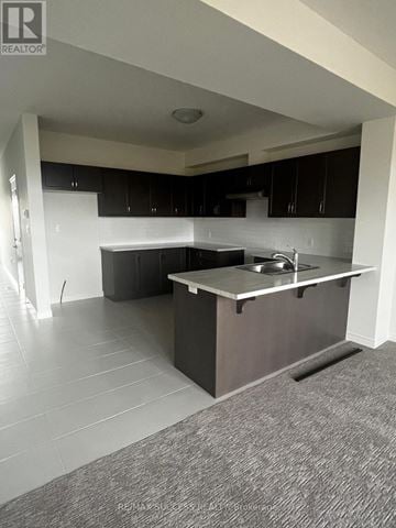 Hamilton townhouse for rent - A kitchen with a sink and cabinets.