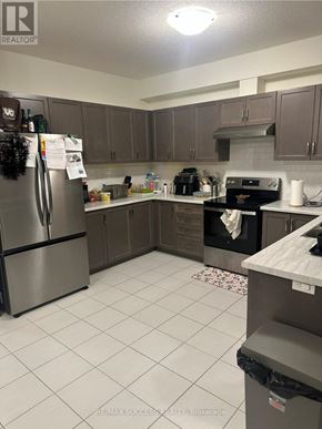 Hamilton townhouse for rent - A room with a window and a carpeted floor.