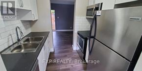 St. Catharines (Carlton/Bunting) townhouse for rent - A kitchen with a stainless steel refrigerator and a sink.