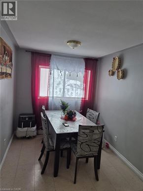 Kitchener condo for rent - A dining room with a table and chairs.