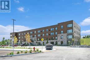 Arnprior condo for rent - A large building with a parking lot in front of it.