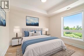 Arnprior condo for rent - A bedroom with a large bed and a window overlooking a green landscape.