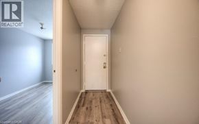 Kitchener townhouse for rent - A hallway with a white door and wooden floor.