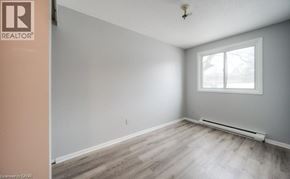 Kitchener townhouse for rent - A room with a window and a wooden floor.