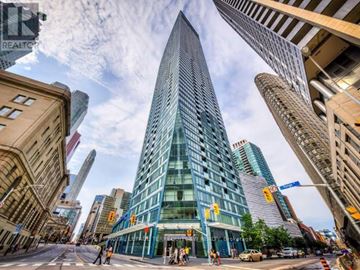 Toronto (Waterfront Communities) condo for rent - A living room with a brown sofa and a white coffee table.
