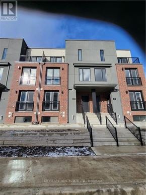 Waterloo townhouse for rent - A building with a balcony and a staircase leading to the entrance.