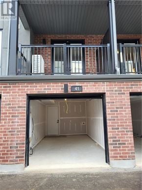 Waterloo townhouse for rent - A garage door is open to reveal a clean, empty garage inside.