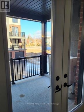 Waterloo townhouse for rent - A balcony with a black railing and a door with a black handle.