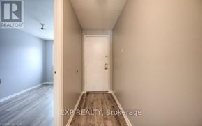 Kitchener townhouse for rent - A hallway with a white door and a light switch on the wall.
