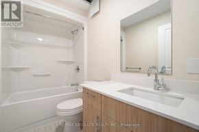 Arnprior house for rent - A white bathroom with a toilet, sink, and bathtub.