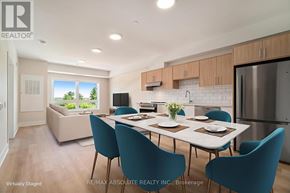 Arnprior condo for rent - A dining room with a table set for four and a kitchen area in the background.