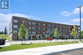 Arnprior condo for rent - A large building with a parking lot in front of it.