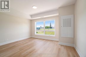 Arnprior condo for rent - A room with a large window overlooking a landscape.