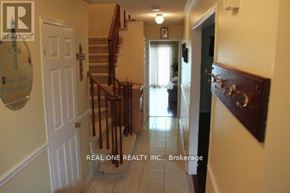Oakville (Ga Glen Abbey) townhouse for rent - A hallway with a staircase and a door on the right.